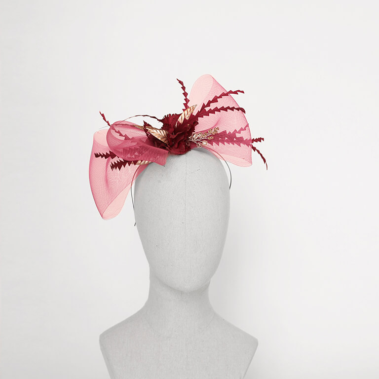 Tocado lazo fucsia con plumas burdeos